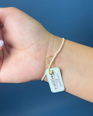 Hope Classic Signature Cross Milkshake Bracelet displayed against a solid blue background. 