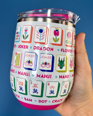 A hand holding a stainless steel insulated tumbler with a clear lid, decorated with a colorful Chinese mahjong tile pattern