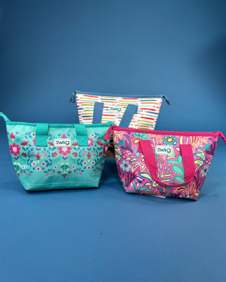 Swig Lunchi insulated lunch bag in multiple colorful prints with waterproof exterior, zipper closure, carry handles, and food-safe insulated lining.