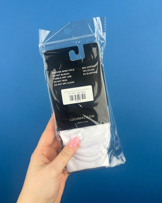 Lulu Mac Half-Crew Seamless Toe Single Pair Socks. In colors Hot Pink, Light blue, Orange, Grey, and Tan. Displayed against a solid blue background. 