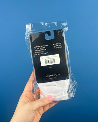 Lulu Mac Half-Crew Seamless Toe Single Pair Socks. In colors Hot Pink, Light blue, Orange, Grey, and Tan. Displayed against a solid blue background. 