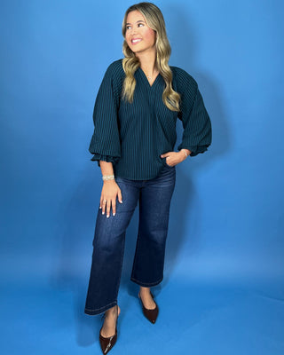 Teal and navy striped V-neck blouse with a relaxed fit and three-quarter balloon sleeves