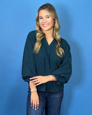 Teal and navy striped V-neck blouse with a relaxed fit and three-quarter balloon sleeves