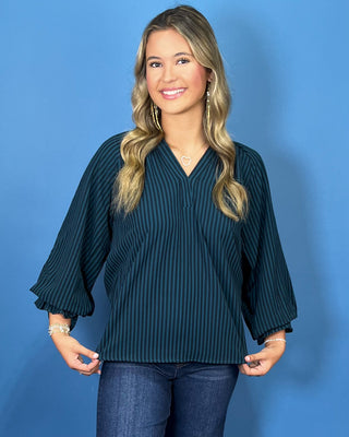 Teal and navy striped V-neck blouse with a relaxed fit and three-quarter balloon sleeves