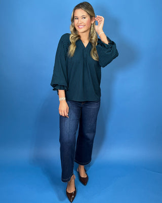Teal and navy striped V-neck blouse with a relaxed fit and three-quarter balloon sleeves