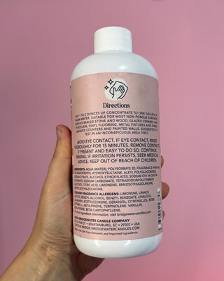 Bridgewater Candle Company Sweet Grace Multi-Surface Cleaning Concentrate in a 16 oz bottle with a pink striped label, designed to clean sealed wood, stone, tile, laminate, vinyl, countertops, and other non-porous household surfaces while leaving the signature Sweet Grace fragrance.