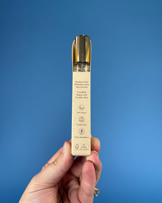 Nemat Amber Eau de Parfum Travel Spray in a 0.30 fl oz (9 mL) travel-size bottle with a fine mist spray applicator, featuring a vegan, cruelty-free, paraben-free fragrance in a sleek portable design.