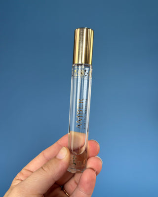 Nemat Amber Eau de Parfum Travel Spray in a 0.30 fl oz (9 mL) travel-size bottle with a fine mist spray applicator, featuring a vegan, cruelty-free, paraben-free fragrance in a sleek portable design.