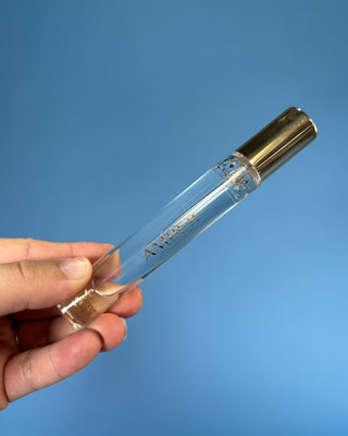 Nemat Amber Eau de Parfum Travel Spray in a 0.30 fl oz (9 mL) travel-size bottle with a fine mist spray applicator, featuring a vegan, cruelty-free, paraben-free fragrance in a sleek portable design.
