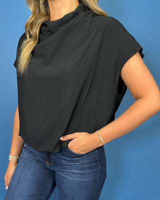 Black short sleeve top with a draped cowl neckline and relaxed silhouette.