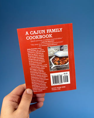 A Cajun Family Cookbook paperback by John Gravois featuring authentic Louisiana Cajun recipes for appetizers, seafood, gumbo, desserts, and traditional Southern family meals.