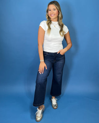 White fitted mock neck short sleeve top with a sleek, smooth finish and classic silhouette.