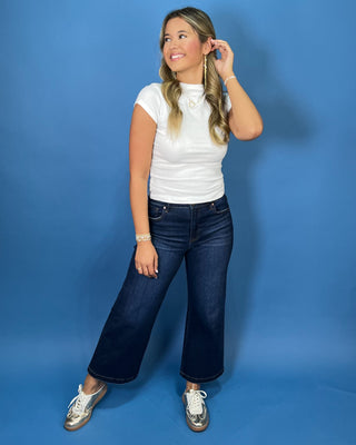 White fitted mock neck short sleeve top with a sleek, smooth finish and classic silhouette.