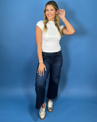 White fitted mock neck short sleeve top with a sleek, smooth finish and classic silhouette.