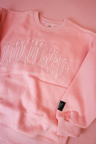light pink crewneck sweatshirt with 'LULU MAC' printed in pink arched letters across the chest