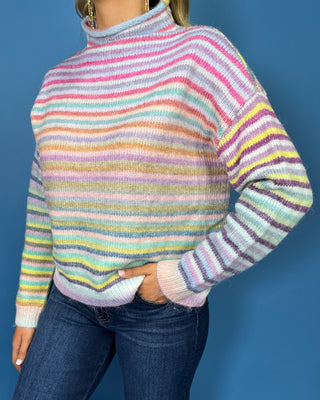 Pastel multicolor striped knit sweater with a cozy mock neckline, long sleeves and relaxed fit.