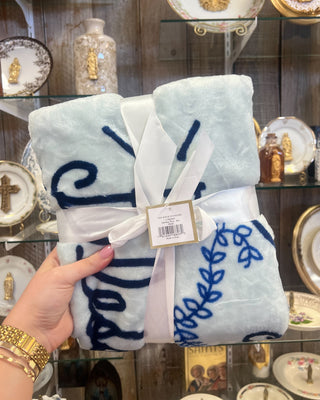 Royal Standard Hail Mary Throw Blanket held up against a store background. 