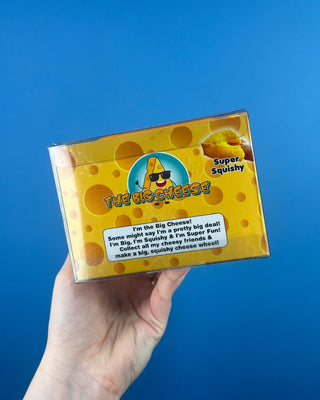 The Big Cheese Triangle Squishy held up against a solid blue background.  