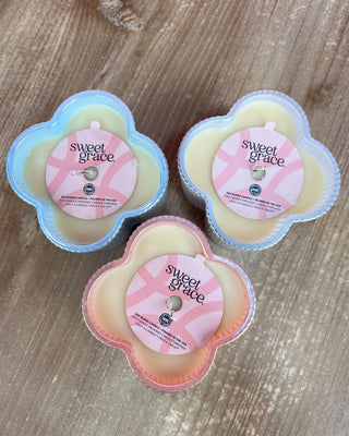 Three 'sweet grace' products on a wooden surface