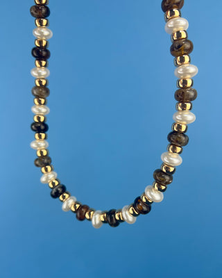 Shop the Coco Beaded Necklace in Brown & Gray featuring marbled beads, faux pearls, gold accents, and an adjustable chain. More Colors available.