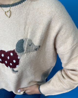 Tan dachshund knit sweater with polka dot dog design, contrast trim, long sleeves, and scalloped hem.