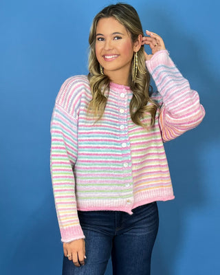 Pastel multicolor striped knit cardigan with white buttons, round neckline, long sleeves, and relaxed fit.