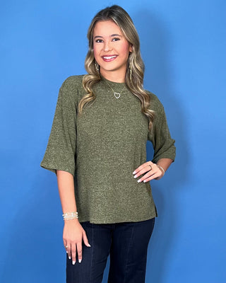 Olive green textured knit top with a round neckline, elbow-length sleeves, and relaxed fit.