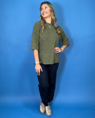 Olive green textured knit top with a round neckline, elbow-length sleeves, and relaxed fit.