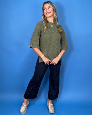 Olive green textured knit top with a round neckline, elbow-length sleeves, and relaxed fit.
