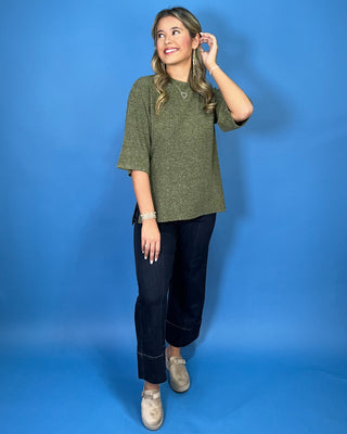 Olive green textured knit top with a round neckline, elbow-length sleeves, and relaxed fit.