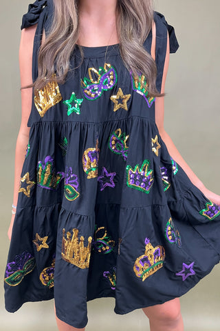 Black dress with colorful embroidery of crowns and stars on a plain background