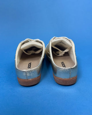 Shop the Stella Metallic Gold Slip On Sneaker featuring a metallic faux leather finish, cushioned comfort, and an easy slip-on design for everyday style.