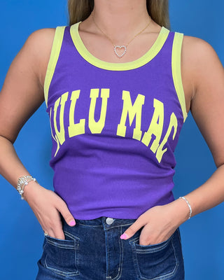 A woman modeling a purple sleeveless tank top with yellow trim and 'LULU MAC' printed in yellow across the front, paired with dark blue jeans