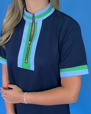 Navy blue top with green and light blue accents on a blue background
