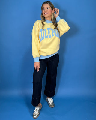 Yellow Lulu Mac sweatshirt with light blue lettering, mock neck, cuffs, and hem for a sporty color-block look.