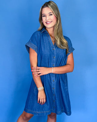 Woman wearing a blue dress against a blue background