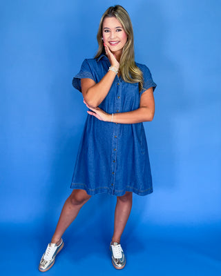 Woman wearing a blue dress against a blue background