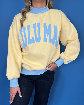 Yellow Lulu Mac sweatshirt with light blue lettering, mock neck, cuffs, and hem for a sporty color-block look.