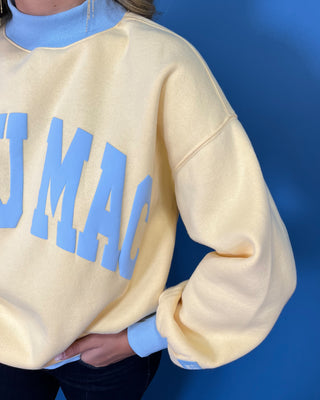 Yellow Lulu Mac sweatshirt with light blue lettering, mock neck, cuffs, and hem for a sporty color-block look.