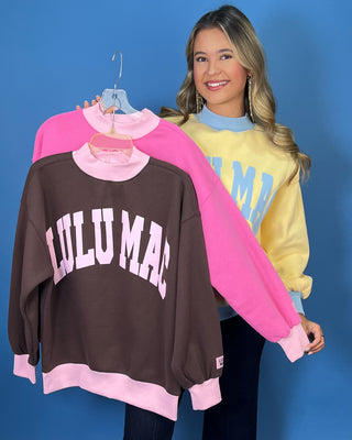 Yellow Lulu Mac sweatshirt with light blue lettering, mock neck, cuffs, and hem for a sporty color-block look.