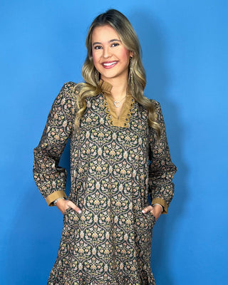 Black floral midi dress with long sleeves, tiered skirt, and contrasting camel ruffle neckline and cuffs.