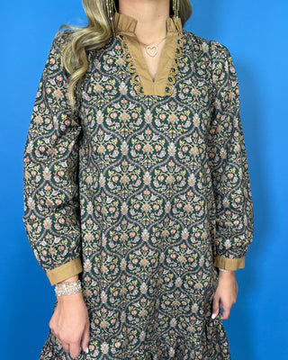 Black floral midi dress with long sleeves, tiered skirt, and contrasting camel ruffle neckline and cuffs.