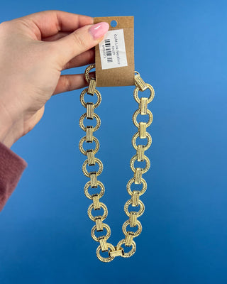 Shop the Gold Link Necklace featuring oversized textured gold links and a stylish toggle clasp for a timeless statement accessory.