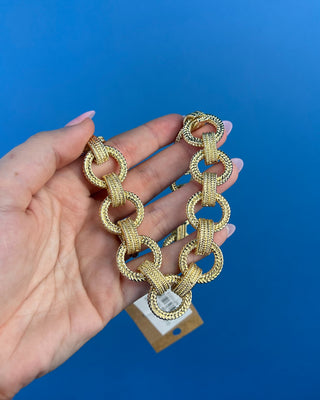 Shop the Gold Link Necklace featuring oversized textured gold links and a stylish toggle clasp for a timeless statement accessory.