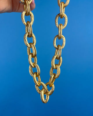 Shop the Keri Gold Link Necklace featuring bold textured oval links, an adjustable extender chain, and a timeless gold statement design.