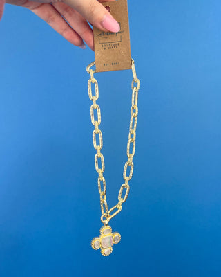 Shop the Chunky MOP Matte Gold Necklace featuring a mother-of-pearl quatrefoil pendant, chunky matte gold paperclip chain, and adjustable fit.