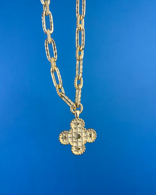 Shop the Chunky MOP Matte Gold Necklace featuring a mother-of-pearl quatrefoil pendant, chunky matte gold paperclip chain, and adjustable fit.