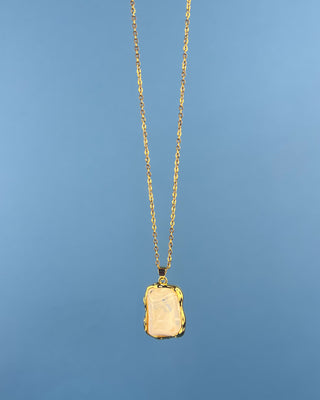 Shop the Opaque Stone Necklace featuring a marbled ivory stone pendant, textured gold frame, and delicate chain for timeless everyday style.