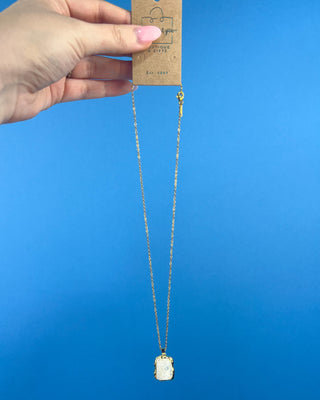 Shop the Opaque Stone Necklace featuring a marbled ivory stone pendant, textured gold frame, and delicate chain for timeless everyday style.