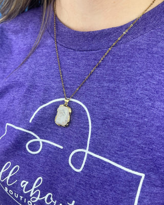 Shop the Opaque Stone Necklace featuring a marbled ivory stone pendant, textured gold frame, and delicate chain for timeless everyday style.